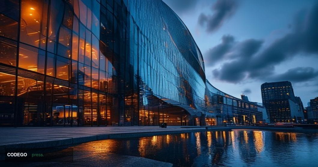 A dramatic cinematic editorial photograph of the Barclays headquarters building in Canary Wharf, London, shot from a low angl