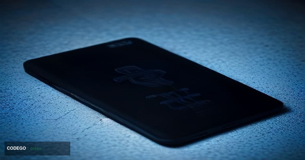 A cinematic editorial close-up of a matte black hardware cryptocurrency wallet device resting on a dark brushed-steel surface
