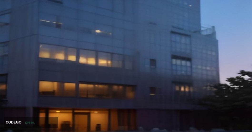 A cinematic editorial photograph taken at dusk outside the Office of the Director of National Intelligence headquarters in Mc
