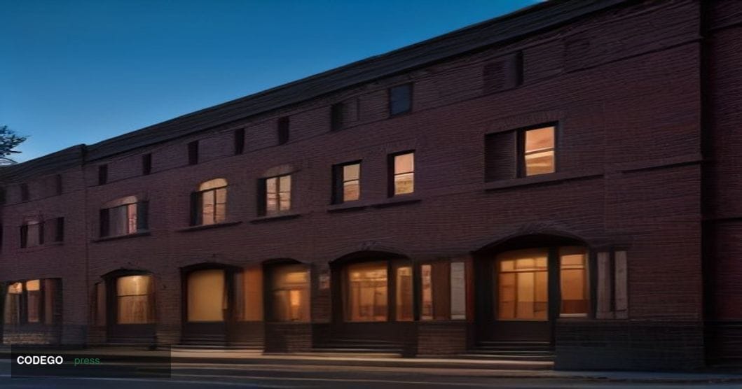 A cinematic editorial photograph of a historic New England-style brick building repurposed as a modern innovation hub in Quin