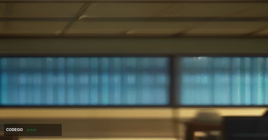 A cinematic editorial photograph of a modern financial trading floor environment captured from a low-angle, wide-lens perspec