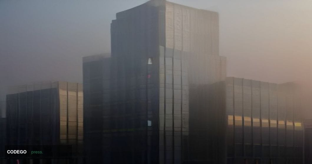 A cinematic editorial photograph of the exterior of a monumental Chinese state bank headquarters building in Beijing, shot at