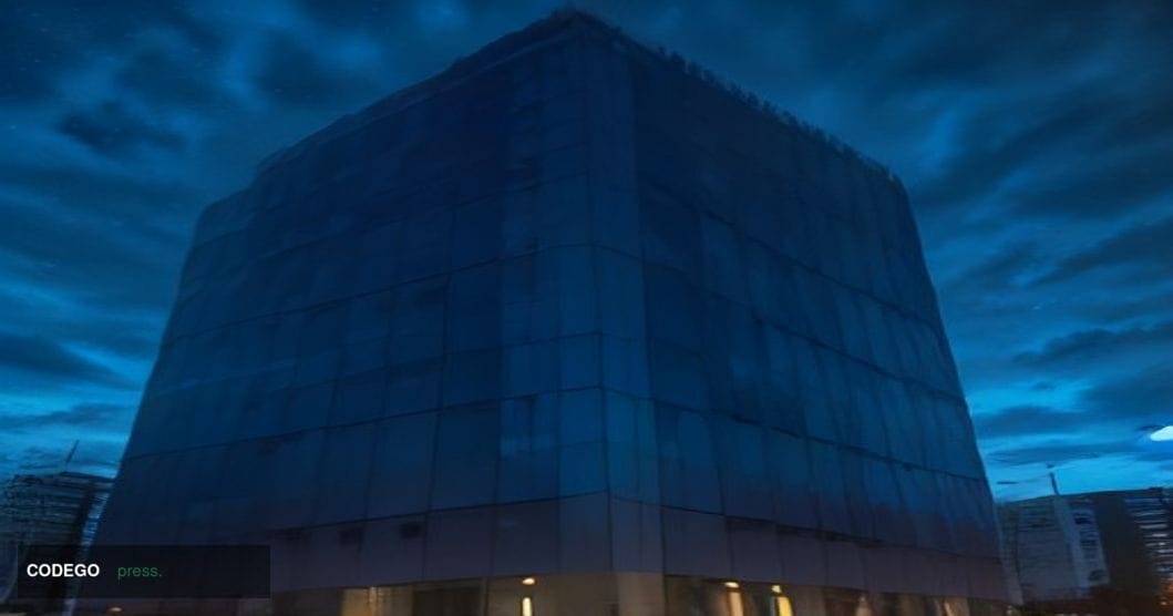 A dramatic cinematic editorial photograph shot at ground level looking upward at a sleek law enforcement command center exter