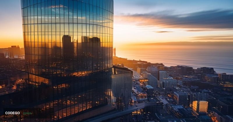 A dramatic aerial view of Affirm's San Francisco headquarters at 650 California Street, captured during golden hour with warm