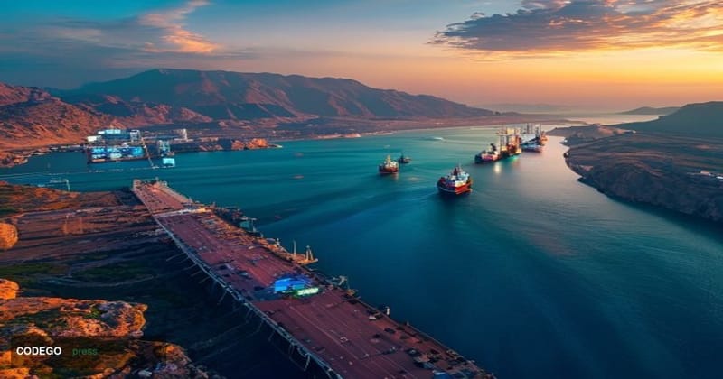 A dramatic cinematic photograph of the Strait of Hormuz at golden hour, showing massive oil tankers navigating the narrow wat