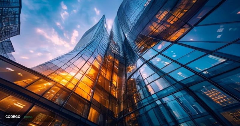 A cinematic editorial photograph of Standard Chartered's distinctive curved glass headquarters building in London's Canary Wh