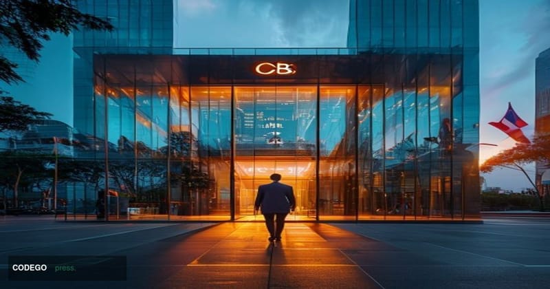 A photorealistic editorial photograph showing the modern glass facade of Orient Commercial Joint Stock Bank's headquarters bu