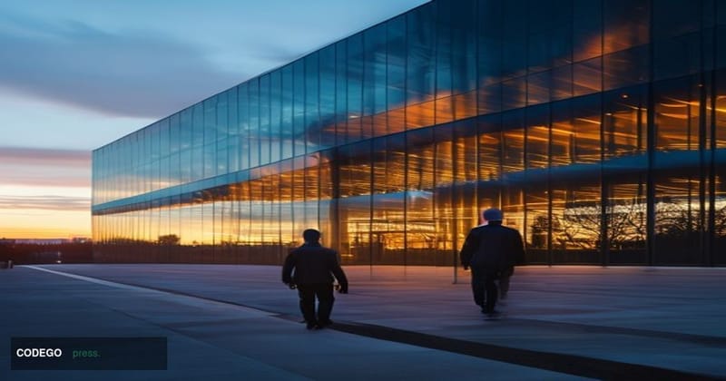 A cinematic editorial photograph taken at dusk outside a large corporate technology campus resembling Amazon Web Services' no