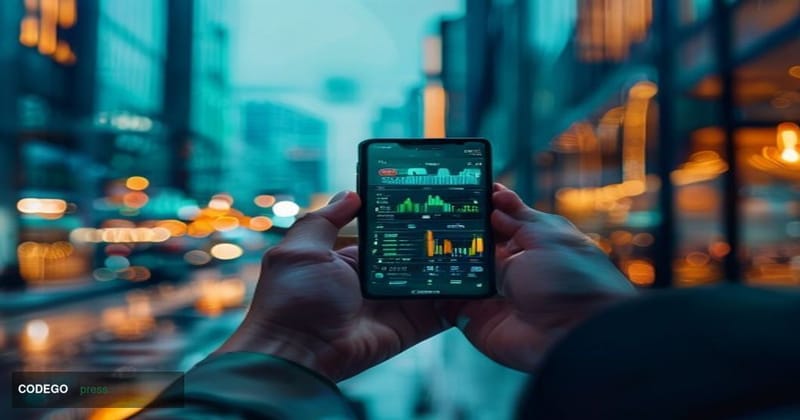 A photorealistic editorial photograph centered on a sleek smartphone held in a human hand, displaying a modern investment por