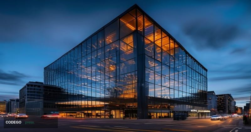 Photorealistic editorial photograph of the iconic Coinbase San Francisco headquarters exterior at dusk, with the building's g