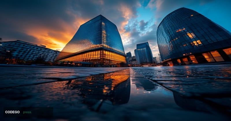 A cinematic editorial photograph shot at dusk from a low angle looking up at Commerzbank's iconic glass tower headquarters in
