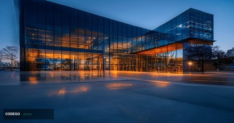 A cinematic editorial photograph of a modern San Francisco technology campus exterior at dusk, with dramatic chiaroscuro ligh