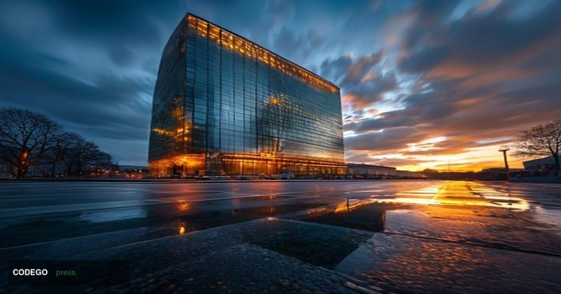 A dramatic wide-angle shot of the European Central Bank's iconic glass-and-steel headquarters tower in Frankfurt, Germany, ph