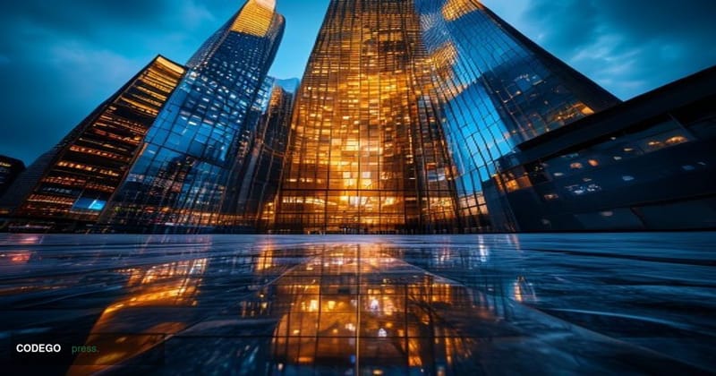 A dramatic cinematic editorial photograph shot from a low angle looking up at the imposing steel-and-glass facade of Goldman 