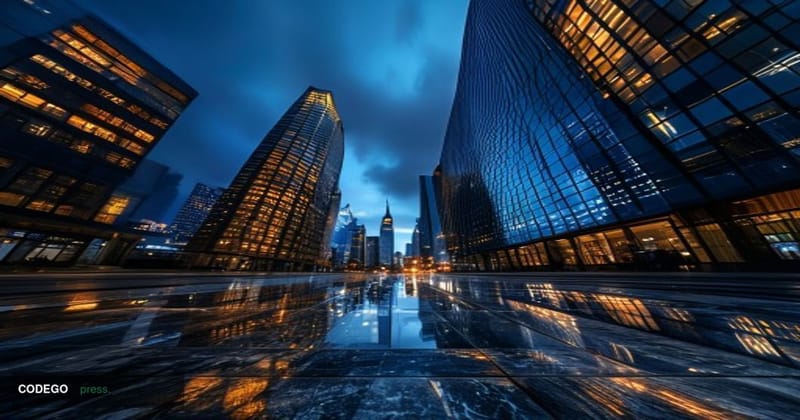 A cinematic editorial photograph taken from a low-angle perspective looking up at the sleek glass-and-steel facade of a major