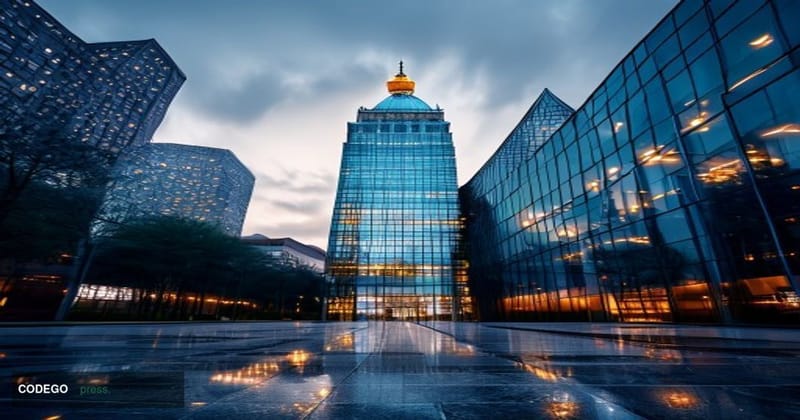 A cinematic editorial photograph taken at ground level looking upward at the glass and steel facade of a corporate insurance 