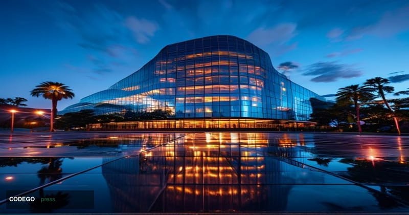 A cinematic editorial photograph of PayPal's corporate headquarters in San Jose, California, shot at dusk from a low-angle pe