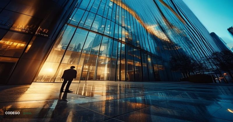 A cinematic editorial photograph shot at low angle looking up at a sleek, modern glass-and-steel European financial district 