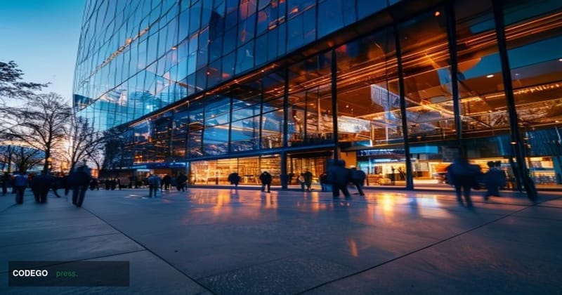 A cinematic editorial photograph of the Robinhood Markets headquarters building in Menlo Park, California, shot at dusk from 
