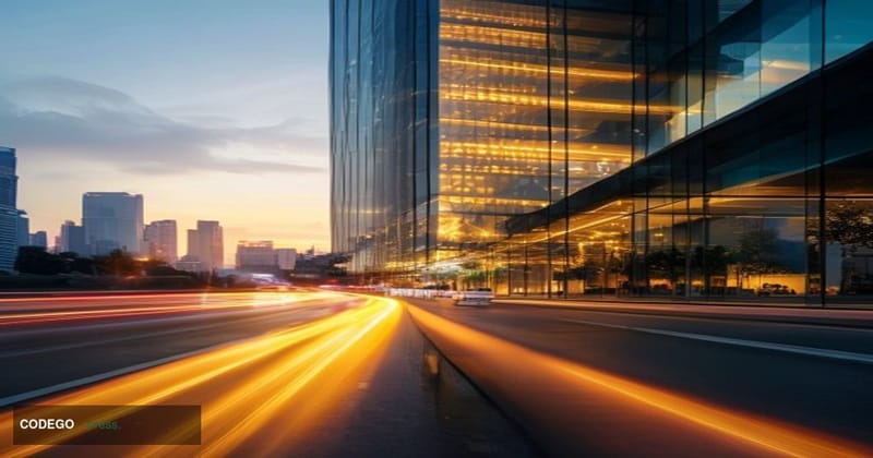 A cinematic editorial photograph shot at dawn from street level looking up at a modern Thai bank headquarters in Bangkok, wit