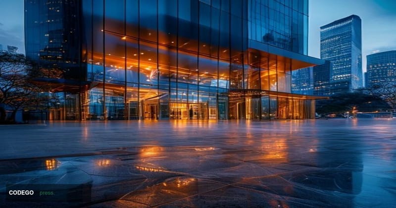 A photorealistic editorial photograph of a sleek modern banking headquarters exterior at dusk, with subtle Sony corporate bra