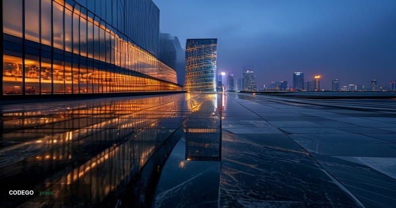 A dramatic cinematic editorial photograph taken at dusk from a low angle looking up at a gleaming modern skyscraper in Shenzh