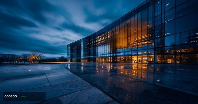 A dramatic cinematic editorial photograph of a sleek, modern glass-and-steel financial technology headquarters at dusk, bathe
