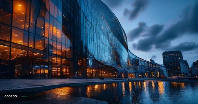 A dramatic cinematic editorial photograph of the Barclays headquarters building in Canary Wharf, London, shot from a low angl