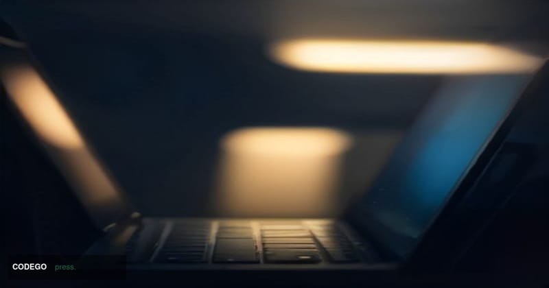 A cinematic editorial photograph shot in a dimly lit environment, depicting a close-up of a sleek laptop keyboard in sharp fo