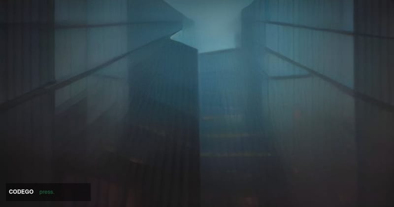 A dramatic cinematic editorial photograph shot from a low angle looking up at the glass-and-steel facade of a mid-sized Ameri