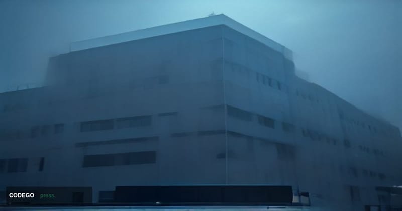 A cinematic editorial photograph shot from a low angle looking up at a modern South Korean police headquarters building at du